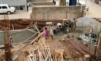 Cement being mixed and carried for construction of a typical house in Vasantnagar, Bangalore