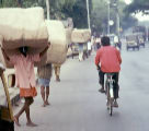 A photo of pedestrians hauling cargo on a Bangalore street.