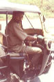 A photo of the front of a Bangalore auto rickshaw, showing driver.